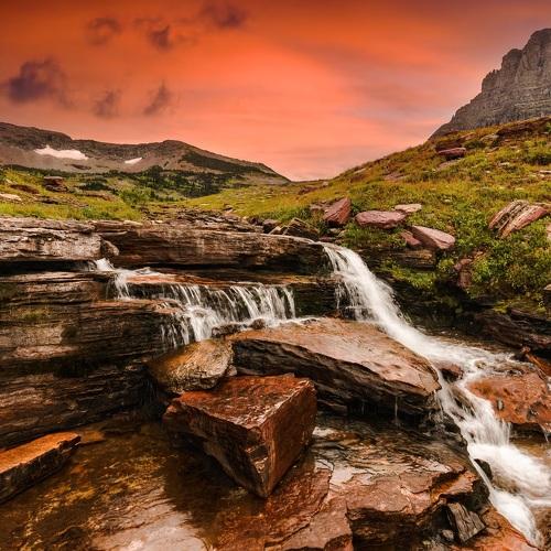 A waterfall during sunset in the mountains