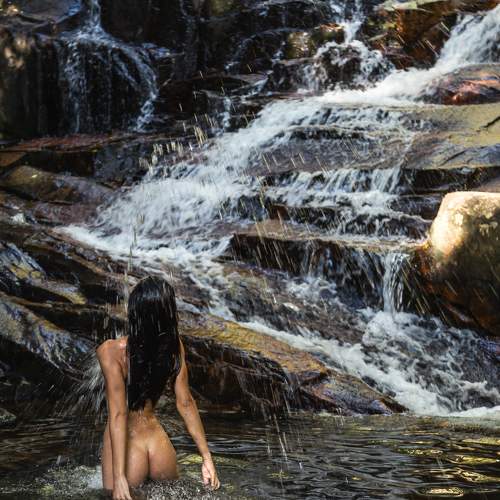 Beautiful woman in waterfall on colors