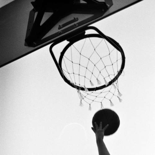 Basketball Player Throws the Ball