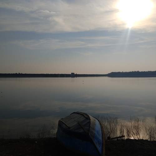 Boat on Shore of the reservoir water