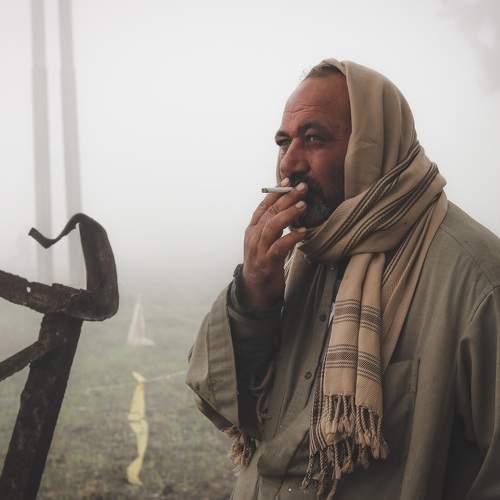 A farmer drinks a cigar
