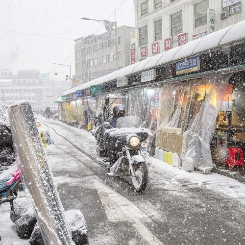 Motorcycle delivery man's winter.