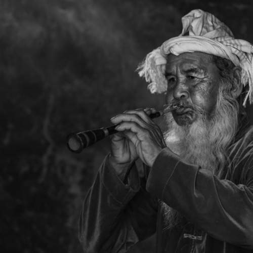 Portrait of Cham ethnic artisan playing Saranai trumpet