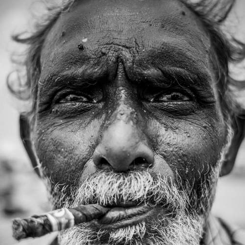 Old man smoke cigarettes..