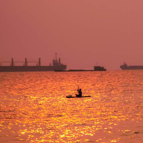 Man Rowing Boat In The Sea