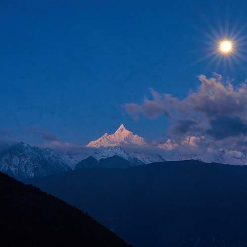 setting moon and snowy mountain