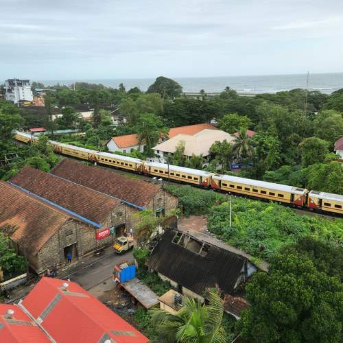 Train moving through Alleppey town Kerala India