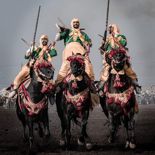 Capture the electrifying moment as gallant knights fire rifles while riding on horseback, showcasing their extraordinary skills