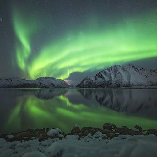 Aurora reflection over mountains