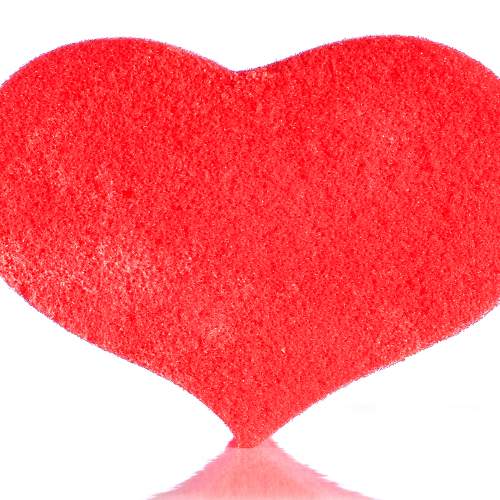 Red heart shaped washcloth on white background