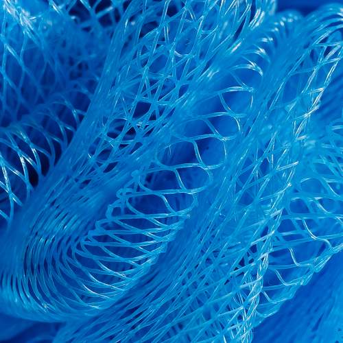 Part of a light blue nylon washcloth close up