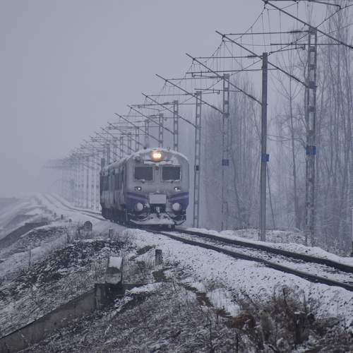 Train is running on the railway track, covered in a thick layer of snow