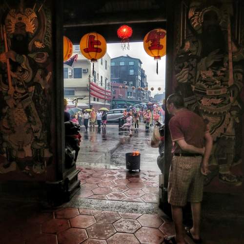 Piety in the rain outside the door