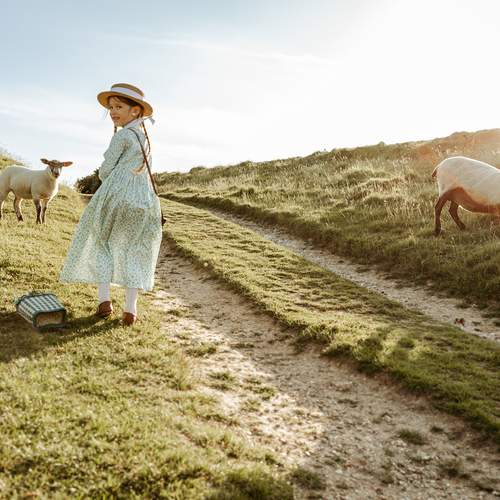 Just a girl and her sheep, soaking up the sunshine.
