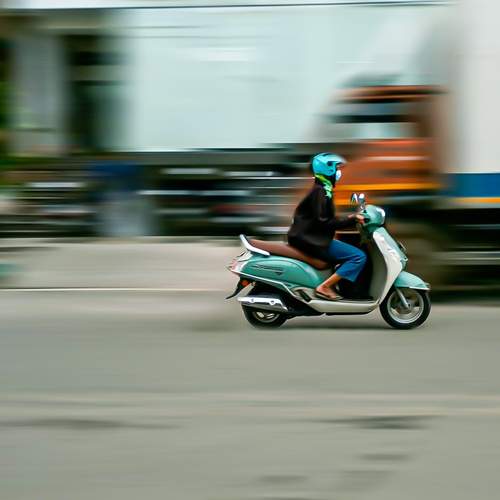 Panning shot of a woman on a scooter