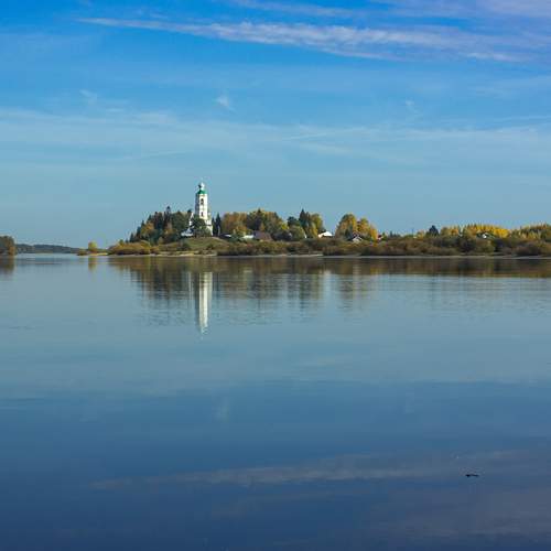 The Kubena River and the Church of Athanasius the Great in the distance on the shore on a clear October day