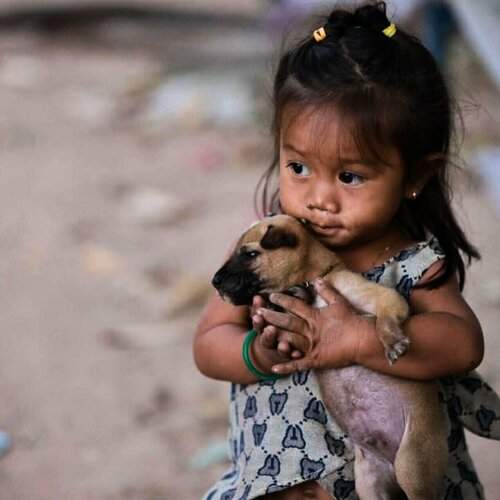Cambodia girl with her puppy.