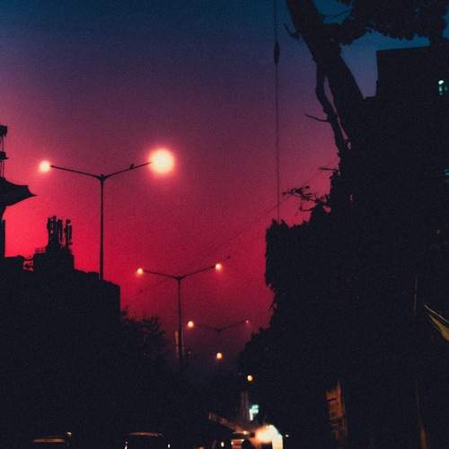 Street lights against the hues of the setting sun