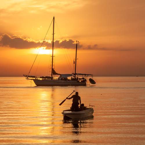 Fisherman beside SailBoat