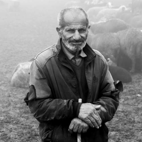 Behind torn clothes stands an unbroken spirit.