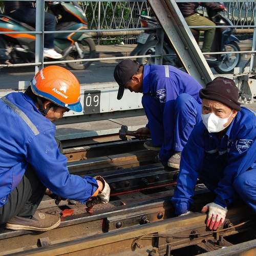 Workers repairing Long Biên Bridge in Hanoi.