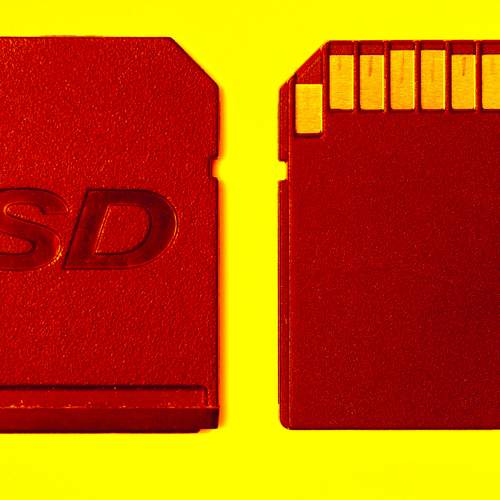 Red memory card and slot cover on a yellow background