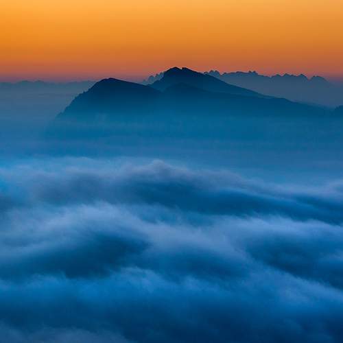 Clouds and lights over Dolomites before dawn
