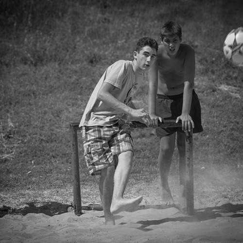 Youth Playing Soccer on a Sandy Field
