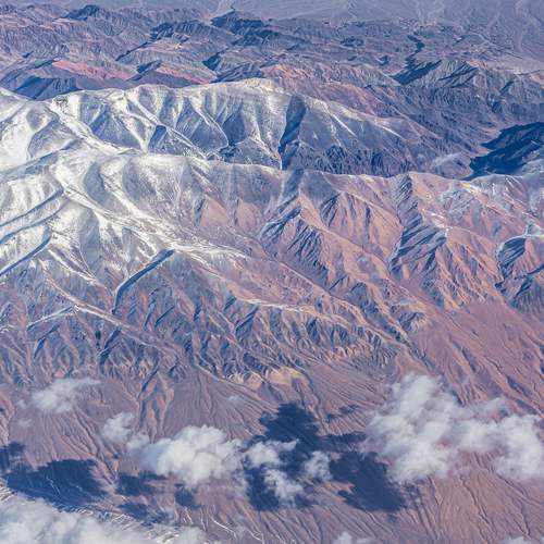 The snow-capped mountain ranges