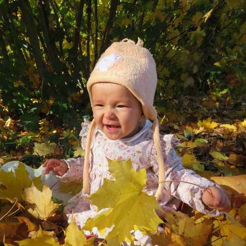 Happy Child Playing With Golden Leaves