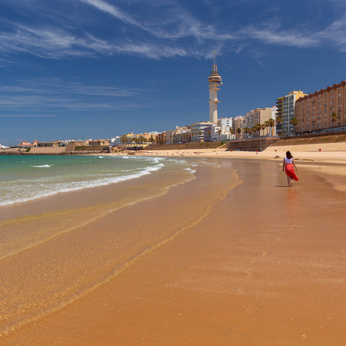 Woman Walking Along La Caleta Beach and Cadiz Waterfront, Andalusia, Spain