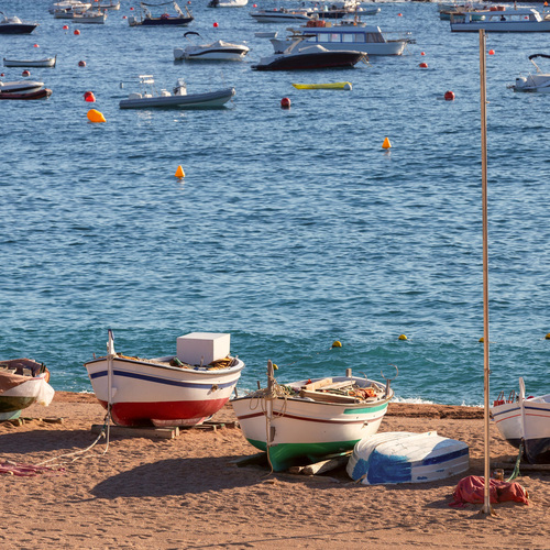 Traditional Fishing Boats on Sandy Beach in Tossa de Mar, Spain