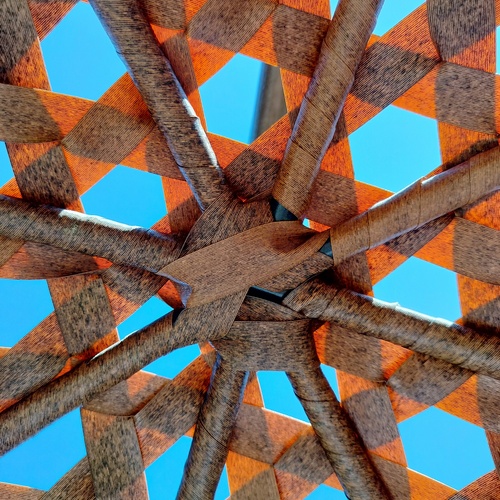 Woven palm leaf beach parasol umbrella