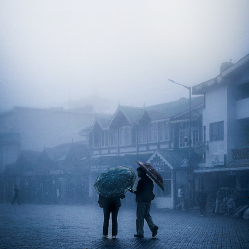 Two souls, one umbrella, endless mist
