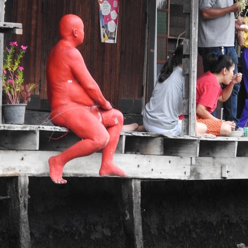 Human statue by the river