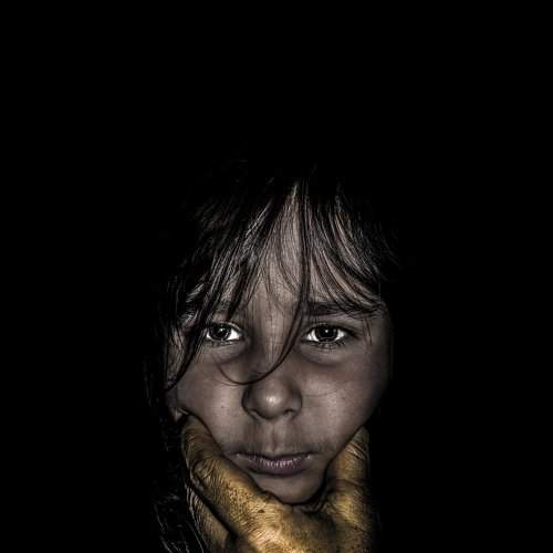Hand against face