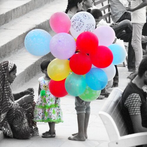 "a childhood hidden behind the baloons for livlihood"