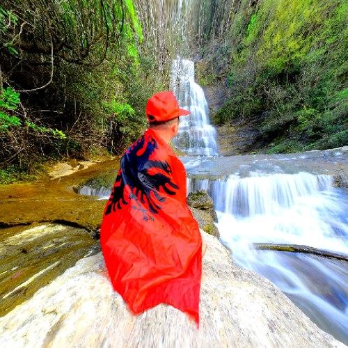 Albanian admiring the waterfall.