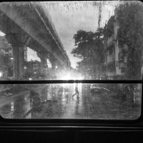 A rainy day viewed from a bus