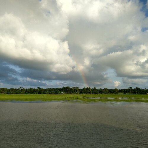 Rainbow under clouds