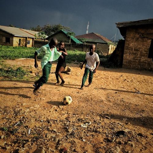 Picture of young African children playing street soccer