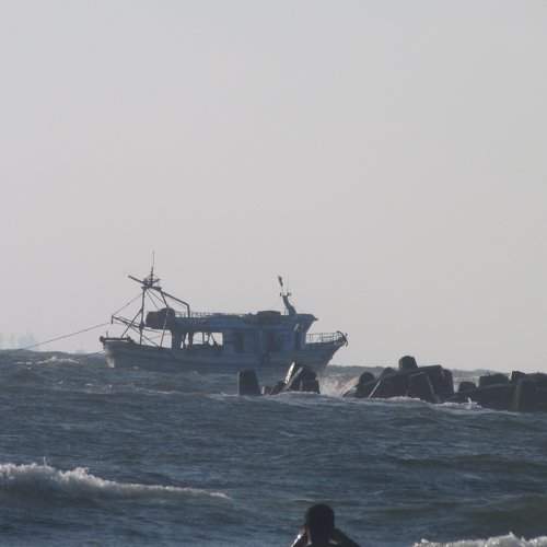 a man swimming near a boat