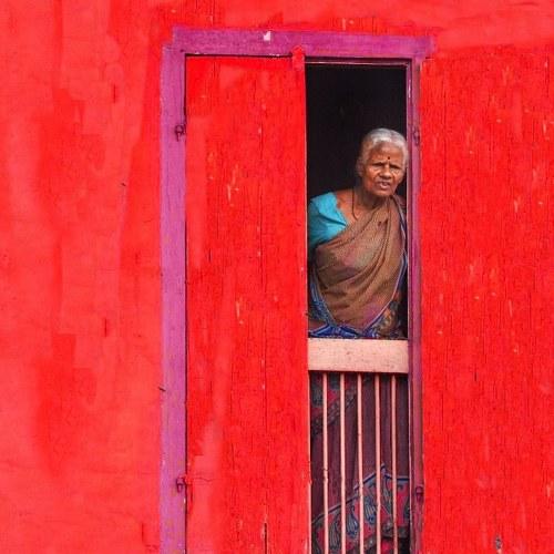 Morning at 8 am old women watching outside of home