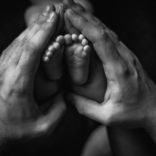 Newborn Feet in Adult Hands