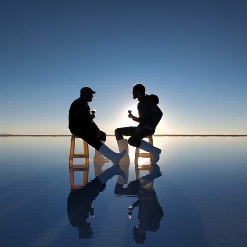 Two friends sitting on a mirror