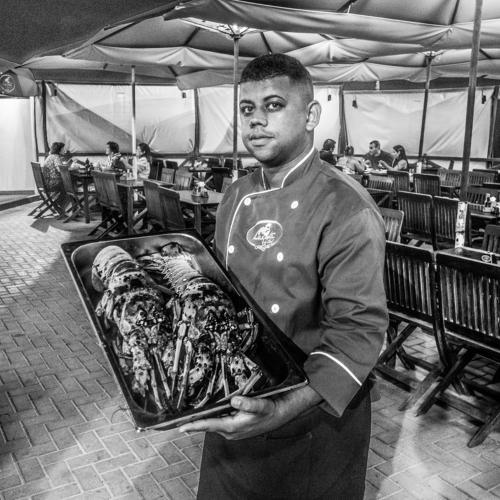 Garcon serving lobster