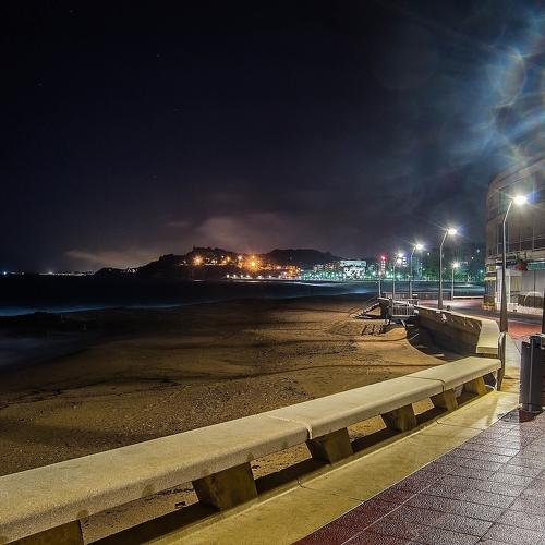 the coast lit by streetlights