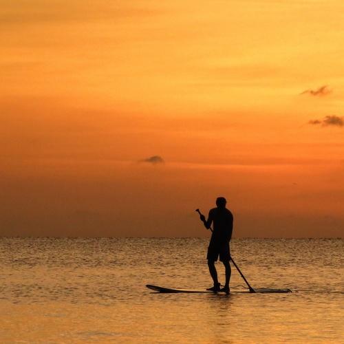 Man boating into the sunset