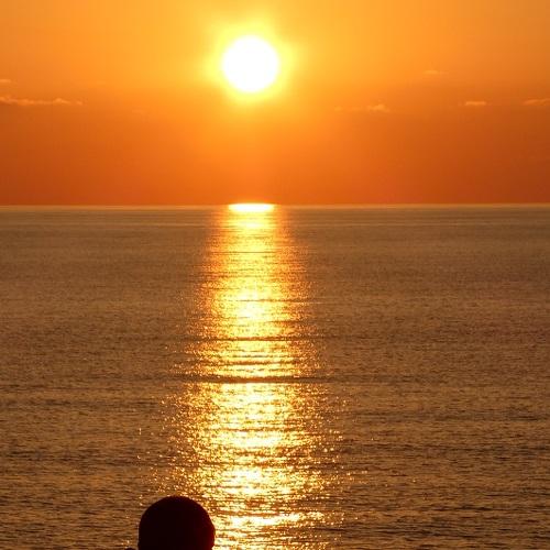 sitting man at sunset