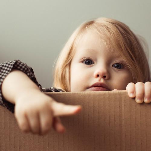 Little girl in a cardboard box